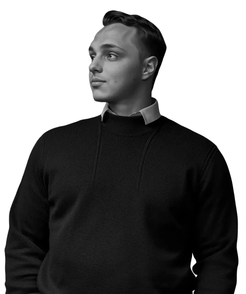 A man wearing a black sweater and a white collar.